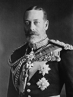 George V is pale-eyed, grey-bearded, of slim build and wearing a uniform and medals.