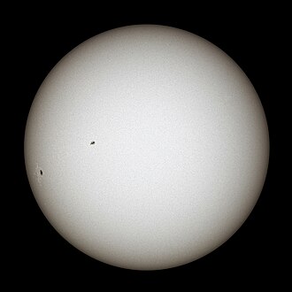 White glowing ball with black sunspots