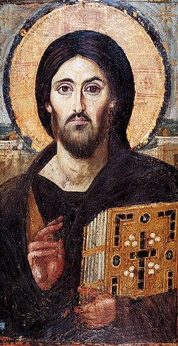 A depiction of Jesus, titled Christ Pantocrator, 6th century AD, holding Bible in front of the sun. Christ's features on his right side (the viewer's left) are theorized to represent the qualities of his human nature, while his left side (the viewer's right) represents his divinity.